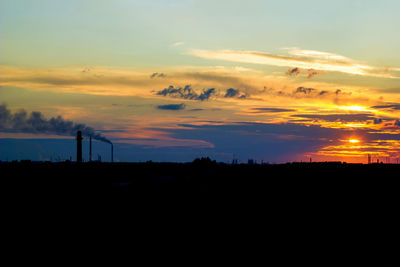 Silhouette landscape against sunset sky