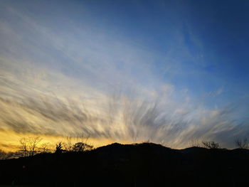 Silhouette landscape against sky during sunset