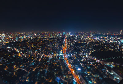 Aerial view of illuminated cityscape against clear sky