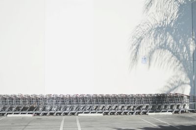 Shopping carts arranged against white wall