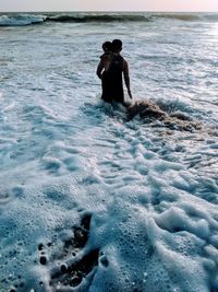 Full length of shirtless man in sea