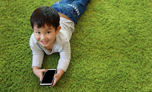 High angle view portrait of boy using mobile phone