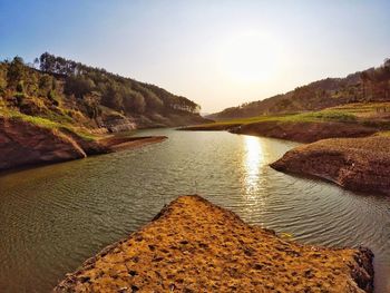 Scenic view of river amidst mountains against clear sky