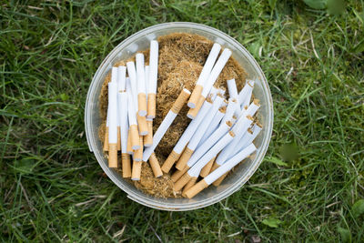 High angle view of cigarette on field