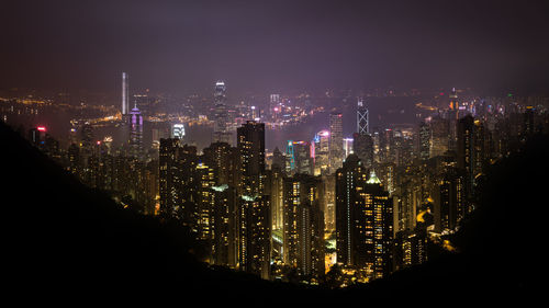 High angle view of two international finance center in city at night