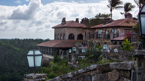 Houses against cloudy sky