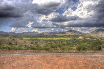 Scenic view of landscape against cloudy sky