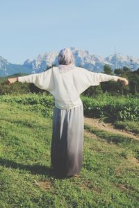 Woman standing on grassy field