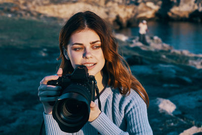 Portrait of woman photographing