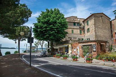 View of promenade in a village at the shore of lake trasimeno, italy.