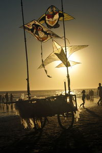 View of people on beach during sunset