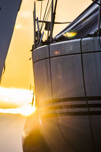 Close-up of airplane against sky during sunset