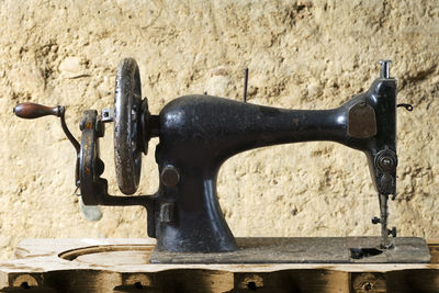 Vintage sewing machine on table in old mud house