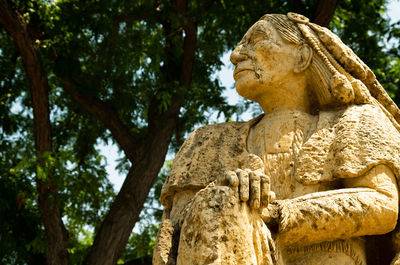 Low angle view of statue against trees