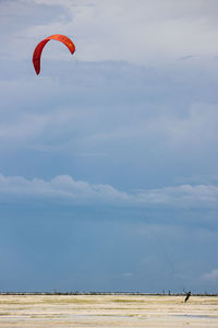 Person paragliding against sky