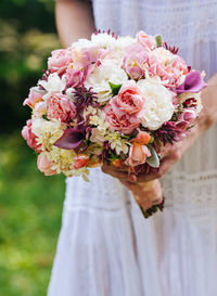 Close-up of plant holding bouquet of red rose flower