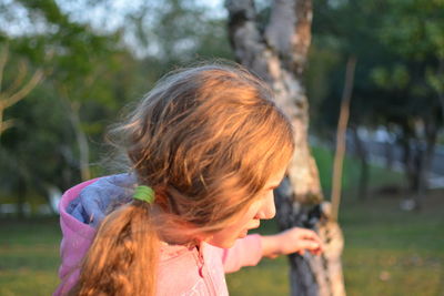 Close-up of teenage girl standing at park