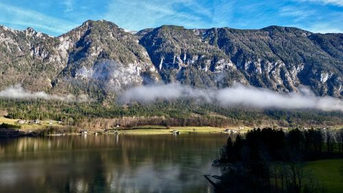 Scenic view of lake and mountains against sky