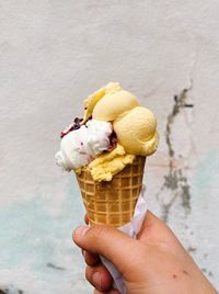 Cropped hand holding ice cream cone