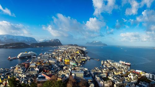 High angle view of townscape by sea against sky. a seascape view across alesund harbour, norway.