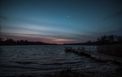 Scenic view of river against sky during winter