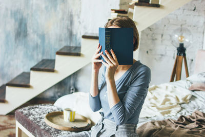 Rear view of woman reading book