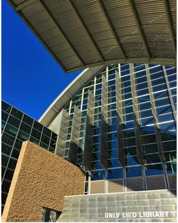 Low angle view of modern office building against blue sky