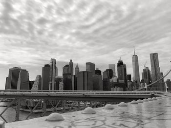 Modern buildings in city against sky during winter