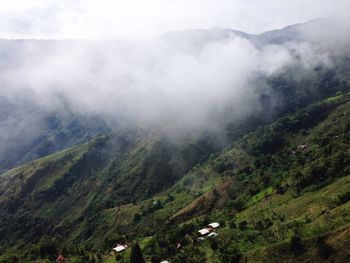 Scenic view of fog over mountains