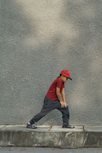 Full length side view of boy on wall