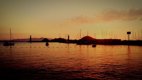 Sailboat in sea at sunset