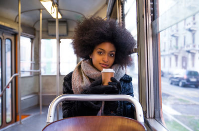 Portrait of beautiful young woman in train