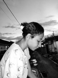 Man on car against sky