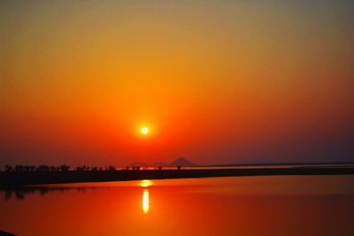 Scenic view of lake against romantic sky at sunset