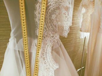 Close-up of wedding dress with tape measure