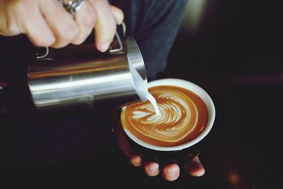 Close-up of hand making coffee