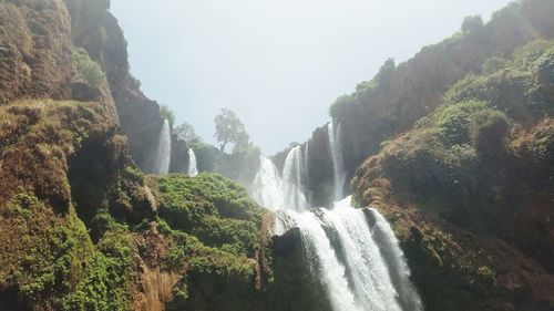 Panoramic view of waterfall in forest against clear sky