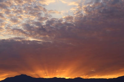 Low angle view of dramatic sky during sunset