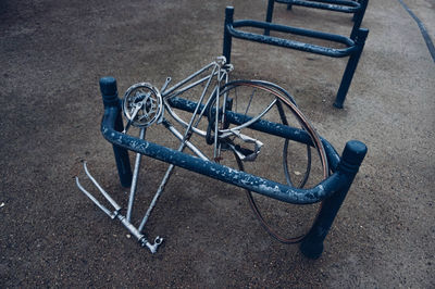 High angle view of damaged bicycle by rack