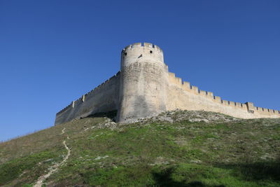 Low angle view of fort against blue sky
