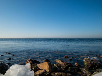 Scenic view of sea against clear blue sky