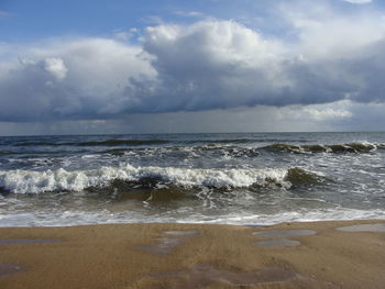 Scenic view of sea against cloudy sky