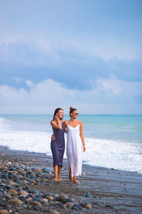 Full length of woman on beach against sky