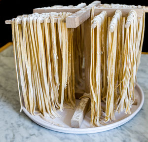 Close-up of raw pasta on wooden stand