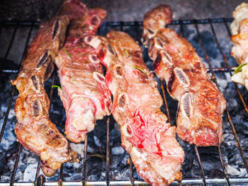 High angle view of meat on barbecue grill