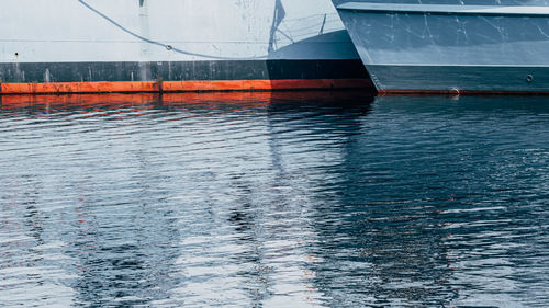 Close up of waterline of two ships in harbour