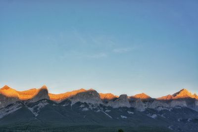 Scenic view of mountains against clear blue sky