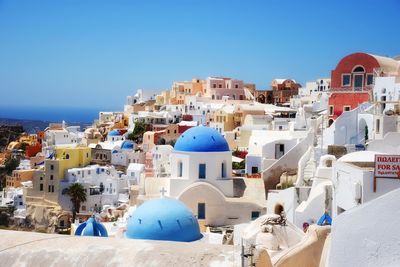 Panoramic view of buildings against blue sky