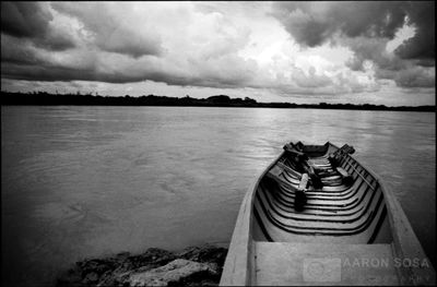 Scenic view of calm lake against cloudy sky