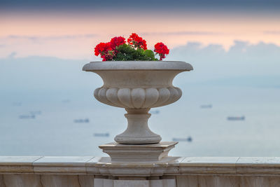 Close-up of red flower pot against sky